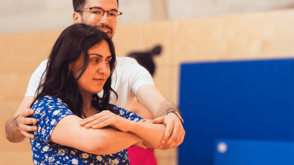 Close-up of partners practicing Argentine tango posture and embrace during a beginner class at Tango Flow in Munich.