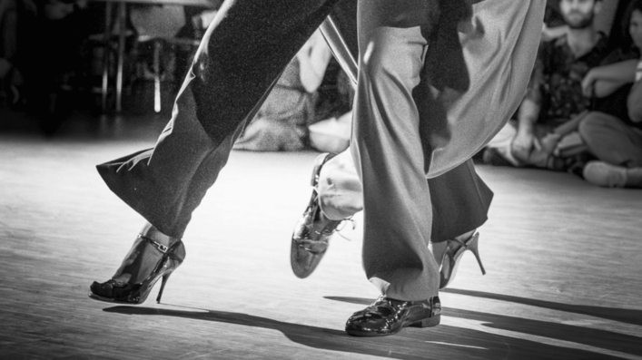 Close-up of tango dancers’ feet showing strength, balance, and weight transfer.